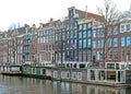 Reflection of Amsterdam famous duch traditional Flemish brick buildings, city canal in Holland, Netherlands Royalty Free Stock Photo